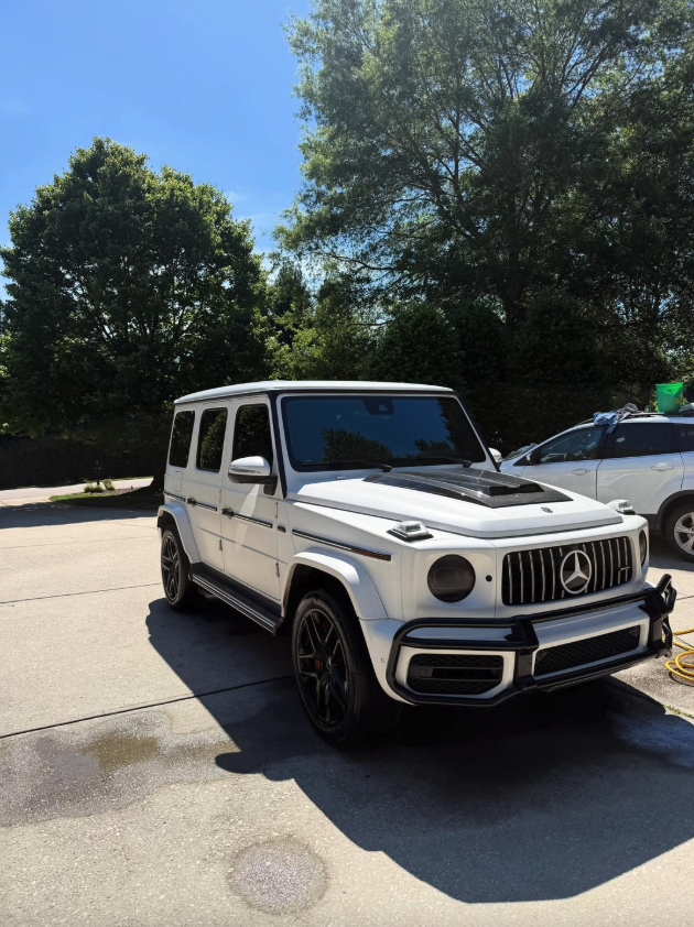 White Mercedes G-Wagon detailed under a blue sky